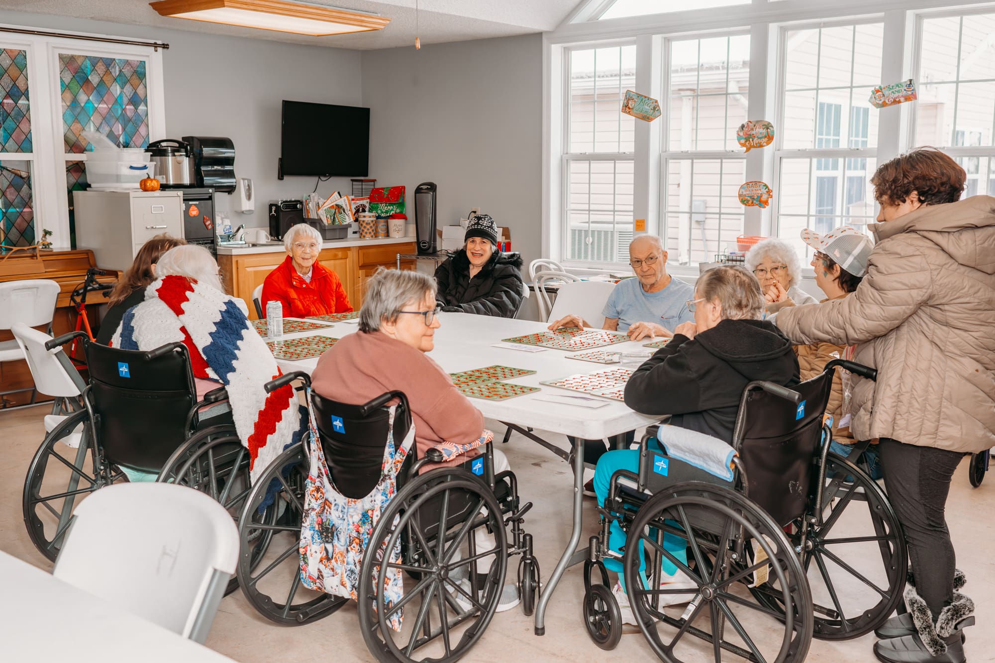 gathering in room with staind glass