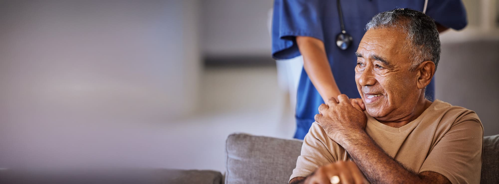 Nurse or doctor give man support during recovery or loss.